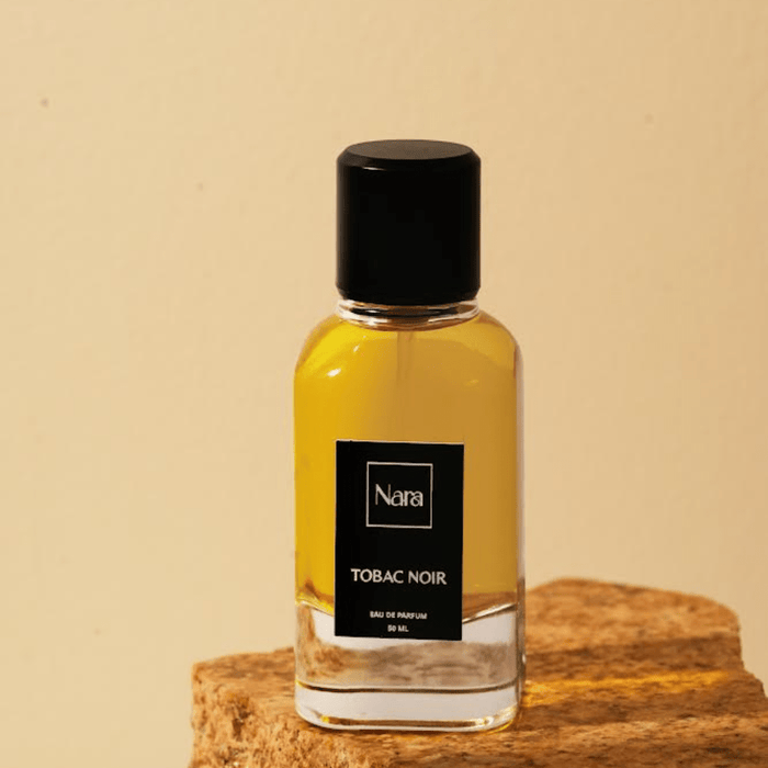 Experience the allure of "Tobac Noir," a luxurious eau de parfum blending sweet vanilla, smoky tobacco, warm spices, and cacao with a hint of ripe fruit. This captivating fragrance offers a powdery softness and woody depth, leaving a trail of intrigue and desire. Embrace the power of an unforgettable scent.